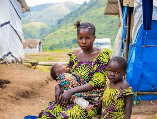 Chance and two of her young daughters at Katashola camp in Kalehe, DRC